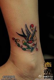 footed color swallow tattoo works by tattoos