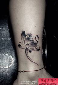 popular female black and white lotus tattoo pattern at the ankle