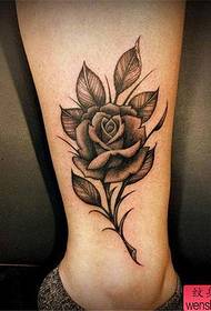 woman's ankle black and white rose tattoo pattern