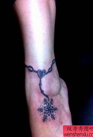 girl's foot a snowflake anklet tattoo pattern