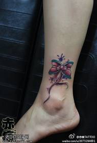 woman's ankle color bow tattoo tattoo works