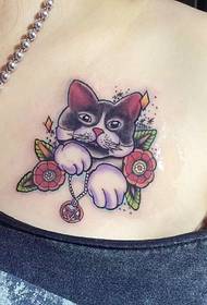 small cat tattoo on the chest