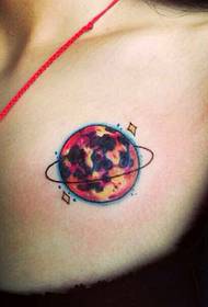 female chest planet tattoo