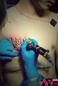 man chest Transformers logo tattoo scene picture