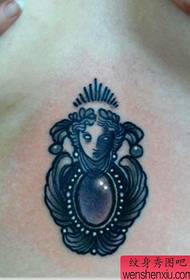 a delicate gemstone tattoo pattern below the chest