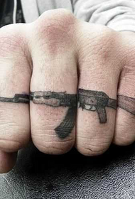 AK47 tattoo combined on the finger
