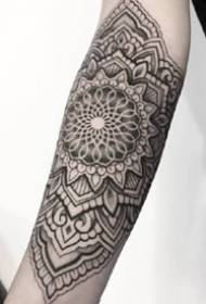 9-pointed flower totem flower arm tattoo on arm