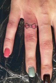 Small bow tattoo on finger