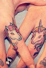 A pair of cute mini pony couple tattoo tattoos on the finger