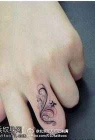 Small and delicate ring tattoo on the finger