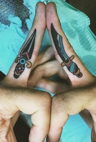 Knife and sword tattoo on middle finger