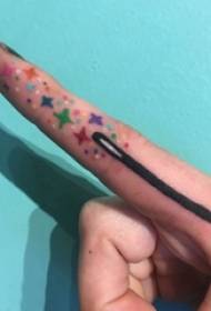 Minimalistic finger tattoo girl's finger on colored magic wand tattoo picture