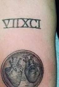 American tattoo star Miley Cyrus arm on dark gray heart tattoo picture