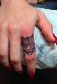 Stylish little animal head tattoo on finger