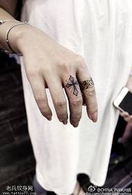 Beautiful cross tattoo pattern on the finger