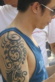 Chinese tattoo star Huang Guanzhong arm on black tribal totem tattoo picture