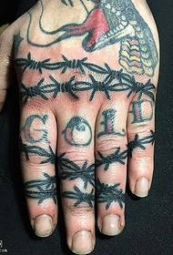 Thorns letter tattoo on finger