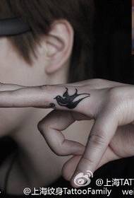 Little swallow tattoo on finger