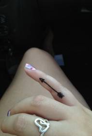 Small arrow tattoo pattern on girl finger