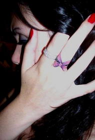 Middle finger beautiful and beautiful bow tattoo