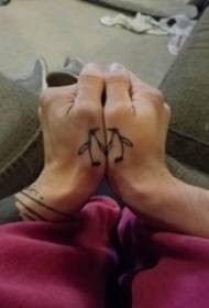 Minimalistic finger tattoo male student finger on black penguin tattoo picture