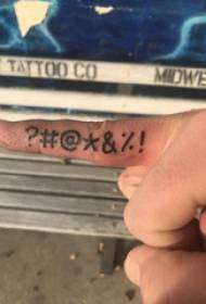 Minimalistic finger tattoo male student finger on black symbol tattoo picture