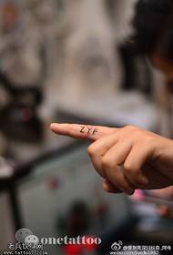 Simple letter tattoo on finger
