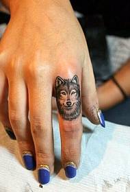 Handsome wolf tattoo picture on female finger
