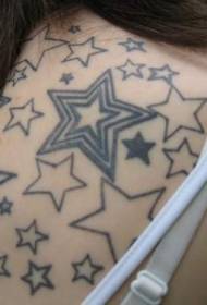 Minimalistic five-pointed star tattoo on the shoulder