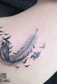 Elegant feathered swallow tattoo on the shoulder
