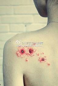 a few fresh flower tattoos on the shoulders