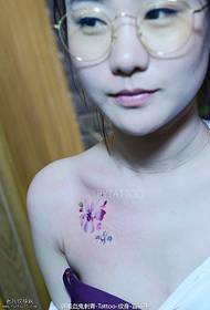 Beautiful small flower tattoo on the shoulder