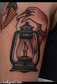 Oil lamp tattoo on the shoulder