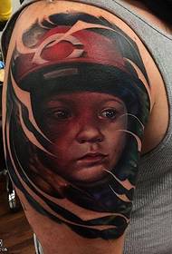 Child's tattoo with a helmet on the shoulder