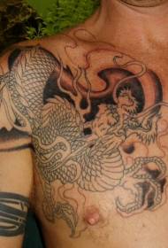 Large dragon tattoo pattern on man shoulder