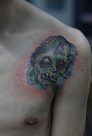 Un bellu tatuatu di zombie maschile annantu à l'ispalla di un zitellu
