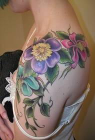 Stylish female shoulders bright flower tattoo