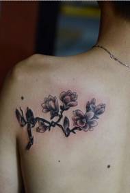 Beautiful looking orchid tattoo on the back shoulder