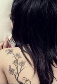 美しい少女の肩の新鮮な花の木の入れ墨の写真