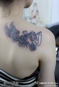 Shoulder stinging unicorn tattoo