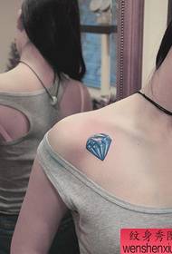 a woman's shoulder colored diamond tattoo pattern