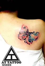 Женское плечо цвета всплеск чернил татуировки бабочки