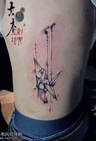 a simple paper crane tattoo pattern at the waist