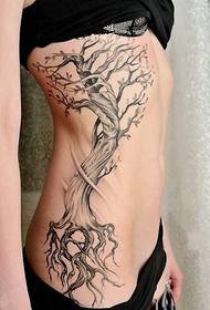 a large tree tattoo picture on the side of the woman's waist