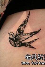 a woman's waist swallow tattoo work