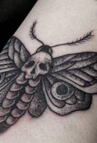 Tattooed arm inside female girl on arm squat and moth tattoo picture