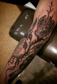 Plant tattoo, male arm, scary piranha tattoo picture
