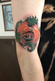 Tattoo cartoon girl's arm on colored pumpkin tattoo picture