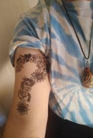 Tattoo symbol girl's arm on flower and question mark tattoo picture