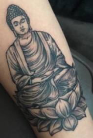 Tattoo image of a tattooed figure of a tattoo of a black and gray Buddha on a girl's arm